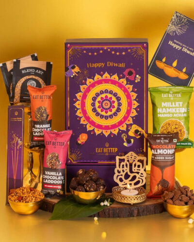 EAT BETTER CO Rangoli Diwali Gift Hamper – 9 Items with Ladoos, Namkeen, Nuts, Diya & Tea Assorted Gift Box (Multicolor)